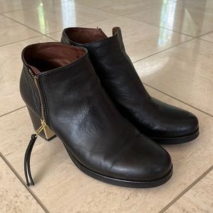 Eric Michael black leather bootie with gold detail at heels